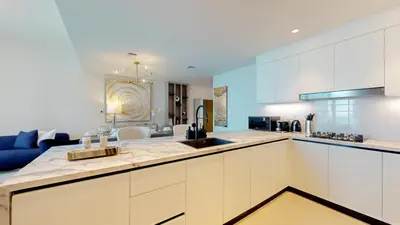 a large kitchen with white cabinets and a blue at Locations I Spacious Modern 3 Bedroom I Luxury Stay Near Dubai Mall & Burj Khalifa I Pool, Gym, Parking & Wi-Fi in Dubai