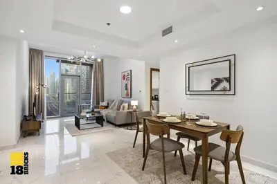 a living room with a table and chairs and a couch at Spacious and Peaceful 1BR with Canal views in Dubai