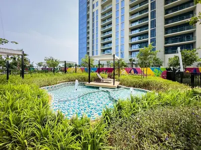 a swimming pool in the middle of a park at Goldbest - Aykon City 2bdr in Dubai