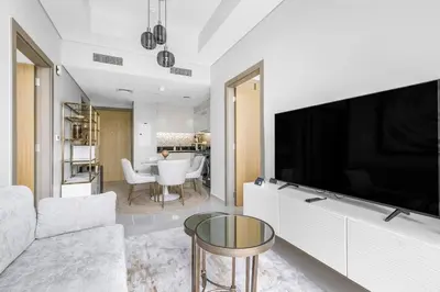 a living room with a large flat screen tv at Goldbest - Aykon City 2bdr in Dubai