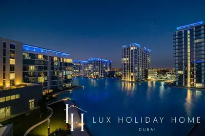 a view of a river at night with buildings at LUX The Burj Khalifa Lagoon View Suite 2 in Dubai