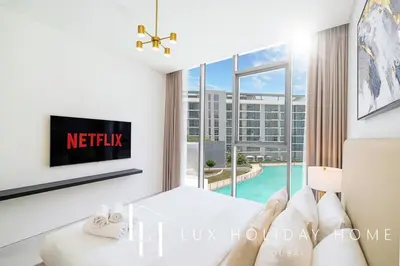 a hotel room with a bed and a large window at LUX The Burj Khalifa Lagoon View Suite 2 in Dubai