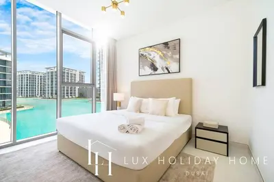 a bedroom with a bed and a large window at LUX The Burj Khalifa Lagoon View Suite 2 in Dubai