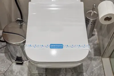 a white toilet in a bathroom with a ruler on it at Canal View Studio Downtown - Near Dubai Mall & Burj Khalifa - MAG 318 in Dubai