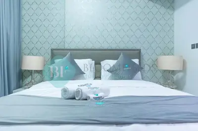 a bed with towels and pillows on top of it at Bloomfields Modern 2br In Arabian Gate in Dubai