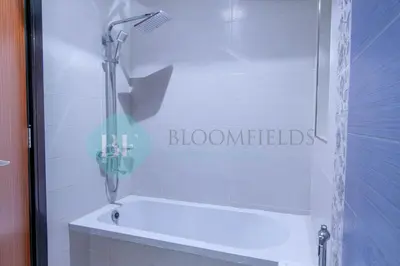 a shower in a bathroom with a glass door at Bloomfields Modern 2br In Arabian Gate in Dubai