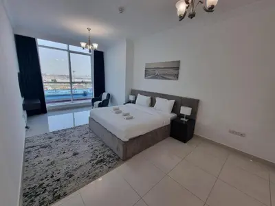 a bedroom with a large bed and a large window at Majestic Tower in Dubai