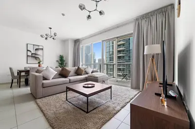 a living room with a couch and a table at Spacious 1 BR Apartment Near in Dubai