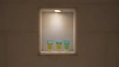 three glasses sitting on a window in a bathroom at Five Palm Residences Sea View in Dubai