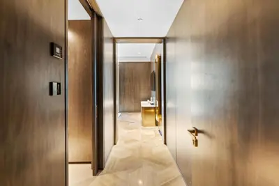 a hallway with a door to a bathroom with a sink at Five Palm Residences Sea View in Dubai
