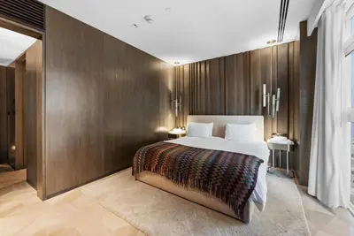 a bedroom with a large bed and wooden walls at Five Palm Residences Sea View in Dubai