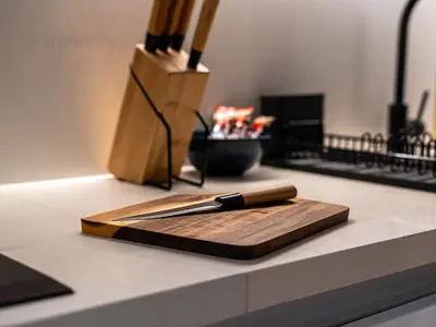 a knife on a cutting board on a counter at Magnificent Studio, Burj Khalifa view, Marquise Sq in Dubai