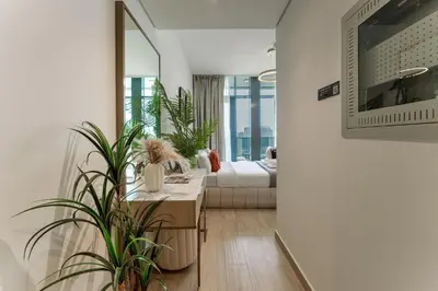 a living room with potted plants and a couch at Stylish Studio with Gym & Pool Access in Dubai