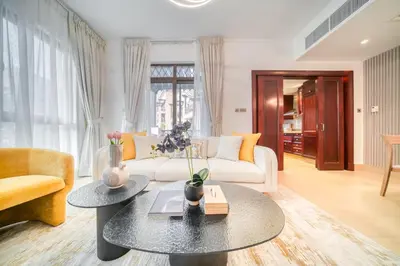a living room with a white couch and a table at Upscale 1-Bedroom Apt with Iconic Burj Khalifa View in Dubai