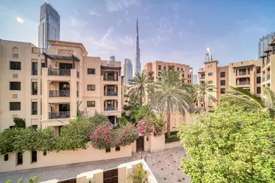 a view of a city with buildings and palm trees at Upscale 1-Bedroom Apt with Iconic Burj Khalifa View in Dubai