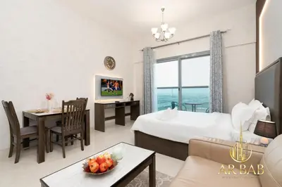 a hotel room with a bed and a living room at Elite Residence - Premium Studio - Best Horse Course View in Dubai