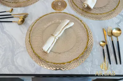 a table with a plate with a napkin on it at Elite Residence - Premium Studio - Best Horse Course View in Dubai