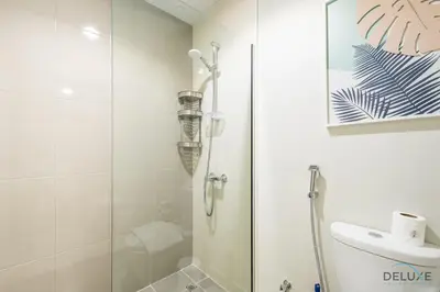 a bathroom with a shower with a glass door at Charming 3BR Townhouse with Study Room in Damac Hills 2 Centaury, Dubailand By Deluxe Holiday Homes in Dubai