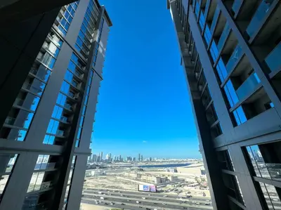 a view of the city from between two tall buildings at Fast Wi-fi Netflix Cozy 1BR Flat Near Downtown Dubai in Dubai