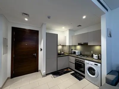 a kitchen with a washing machine and a washer at Pet free 1BR with Balcony Pool Gym Near Downtown in Dubai