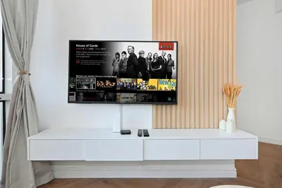 a living room with a tv on a wall at Stunning 2 Bed Great Metro access in Dubai