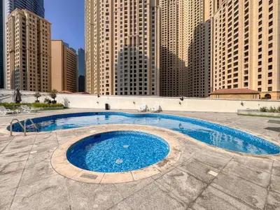 a large swimming pool in a city with tall buildings at ShoresInn - Beautiful residence with Marina Views in Dubai
