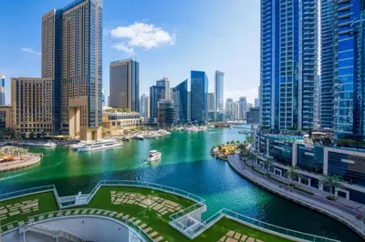 a river in a city with tall buildings at ShoresInn - Beautiful residence with Marina Views in Dubai