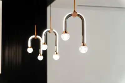 a group of lights hanging from a wall at LA VIE JBR, Sea & Palm View Apartment in Dubai