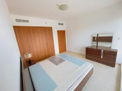 a bedroom with a large bed and a dresser at Luxury Holiday Home Just Minutes from Dubai's Global Village Your Perfect Getaway!