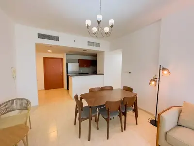 a dining room and living room with a table and chairs at Luxury Holiday Home Just Minutes from Dubai's Global Village Your Perfect Getaway!