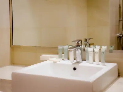 a bathroom sink with toothbrushes and a mirror at Lavish Studio Pool Gym, Balcony, Netflix Fast Wi-Fi in Dubai