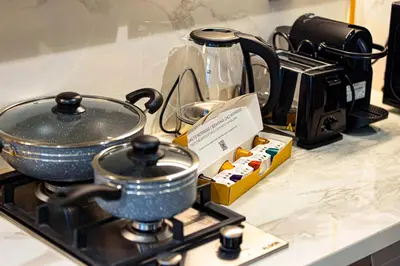 a stove top with pots and pans on a counter at BRAND NEW Studio in Azizi Riviera in Dubai