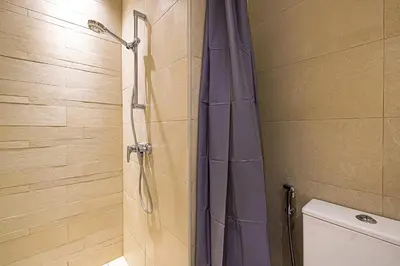 a shower with a purple shower curtain in a bathroom at BRAND NEW Studio in Azizi Riviera in Dubai