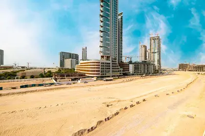 a beach in front of a city with tall buildings at BRAND NEW Studio in Azizi Riviera in Dubai