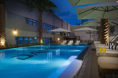 a pool with chairs and umbrellas at a hotel at In Vogue Live On the Canal in Business Bay in Dubai