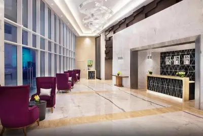 a lobby with purple chairs and a fireplace at In Vogue Live On the Canal in Business Bay in Dubai