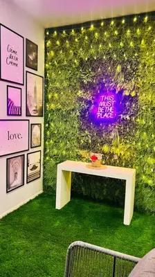 a room with a wall covered in ivy with a table at Gorgeous 2BR with full Burj Khalifa view, 5 mins from Dubai Mall in Dubai