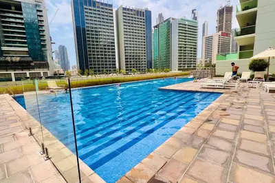 a swimming pool in a city with tall buildings at Gorgeous 2BR with full Burj Khalifa view, 5 mins from Dubai Mall in Dubai