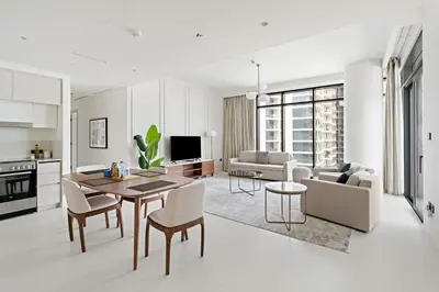 a kitchen and living room with a table and chairs at Silkhaus Family Ideal & High Floor 2BDR in Dubai