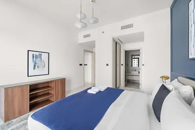 a bedroom with a blue and white bed in a room at Silkhaus Family Ideal & High Floor 2BDR in Dubai