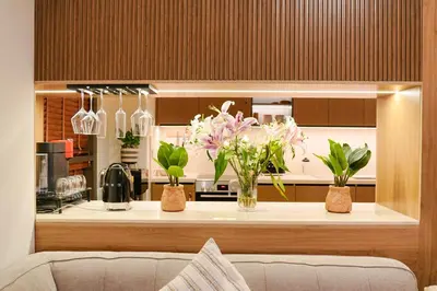a kitchen with two vases of flowers on a counter at Luxury Downtown Dubai Burj Khalifa & Fountain View in Dubai