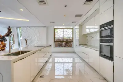 a white kitchen with a sink and a window at World Class Luxurious 6 BDR Villa In Palm Jumeriah in Dubai