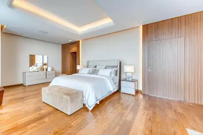 a large bedroom with a bed and wooden floors at World Class Luxurious 6 BDR Villa In Palm Jumeriah in Dubai