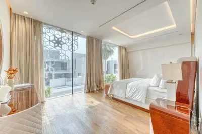 a bedroom with a bed and a large window at World Class Luxurious 6 BDR Villa In Palm Jumeriah in Dubai