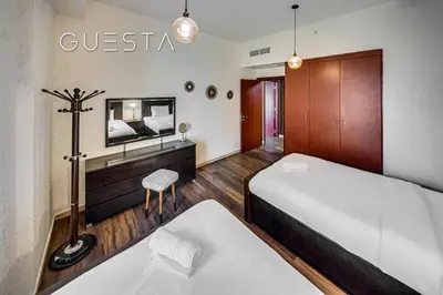 a hotel room with two beds and a tv at Jumeirah Beach Residence - Bahar 1, Dubai Marina in Dubai