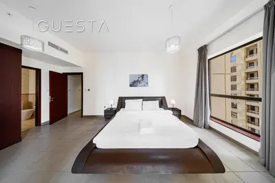 a bedroom with a large bed in a room at Jumeirah Beach Residence - Bahar 1, Dubai Marina in Dubai
