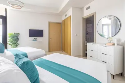 a bedroom with two beds and a mirror at Frank Porter - Aykon City Tower in Dubai