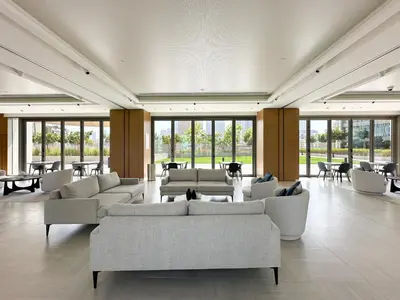 a large room with couches and tables and windows at Sky High Luxury 50th FLR Lux 2BDR Apartment in Downtown in Dubai