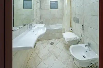 a bathroom with two sinks and a toilet and a tub at Full Sea View in Dubai Marina - Balcony & Pool in Dubai