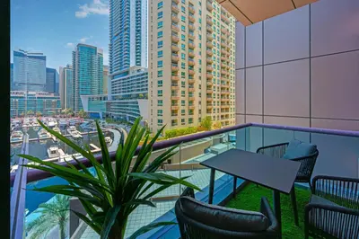 a balcony with a table and chairs and a city at Full Sea View in Dubai Marina - Balcony & Pool in Dubai